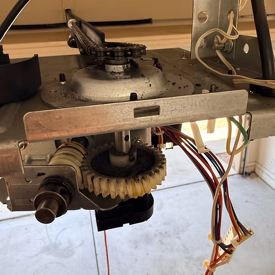 A garage door opener motor and gear assembly.